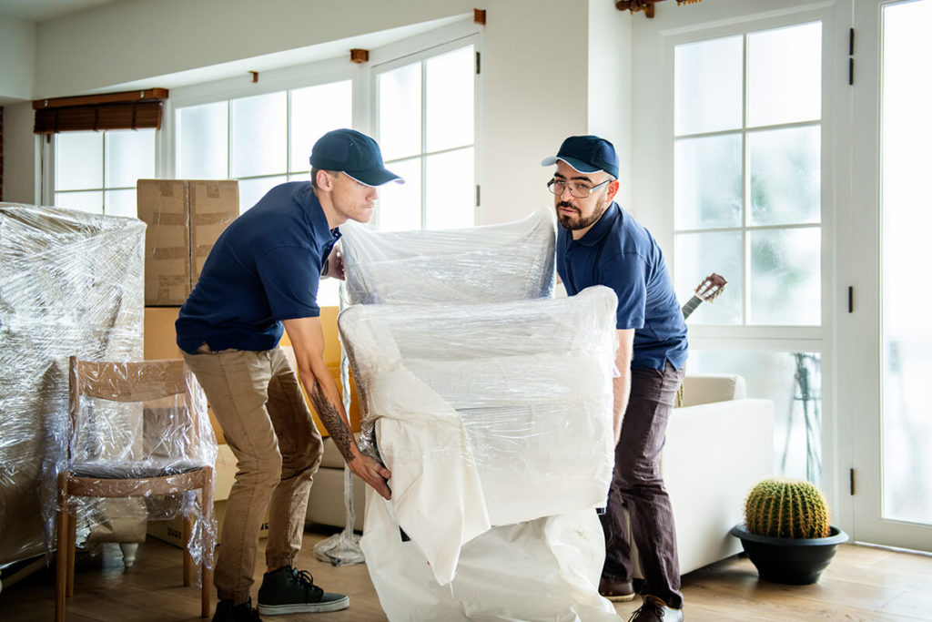 Waters White Vans Employees preparing furniture for the home move